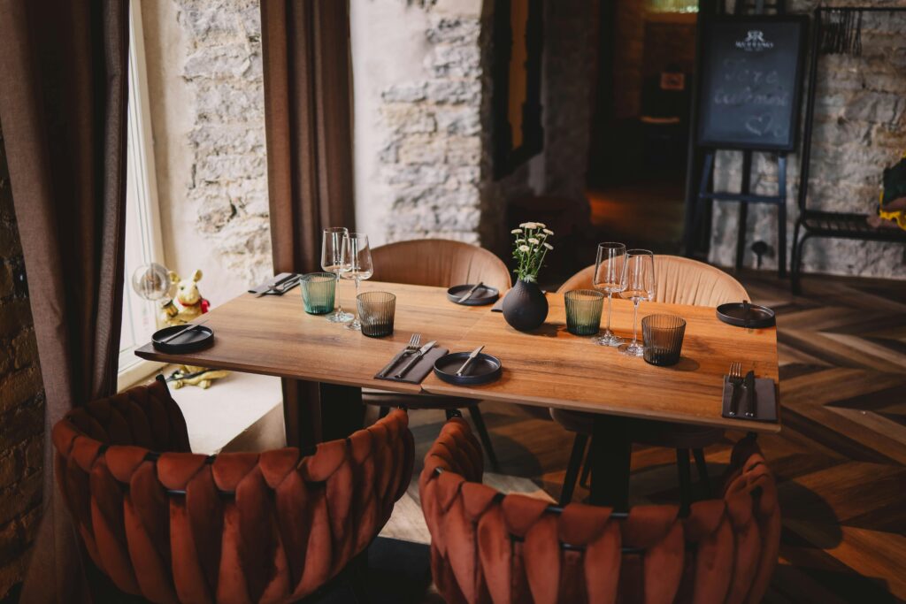 Warm and inviting restaurant table setting with elegant tableware and cozy chairs.